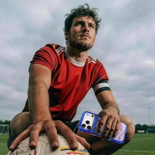 Footballer sitting on the pitch beside a phone in a blue TORRAS case