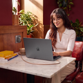 Woman using a FlexLine Pro 60W charger with a laptop