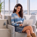 Woman charging a laptop with the FlexLine Pro 60W charger