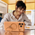 Orange TORRAS Ostand Q3 silicone case with gold magnetic ring stand for iPhone 17 Pro Max.
